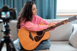 Jovem garota mostrando como colocar os dedos na violão